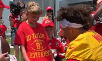 Adorable moment Travis Kelce and Patrick Mahomes make young cancer survivor's day... as superstar Chiefs pair pose for photos - and sign a shirt hailing 'Taylor Swift's boyfriend'