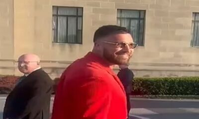 Chiefs star Travis Kelce rocks a VERY bold all-red suit for Super Bowl ring ceremony... but insists his fit isn't a tribute to his girlfriend Taylor Swift's hit song!