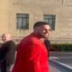 Chiefs star Travis Kelce rocks a VERY bold all-red suit for Super Bowl ring ceremony... but insists his fit isn't a tribute to his girlfriend Taylor Swift's hit song!