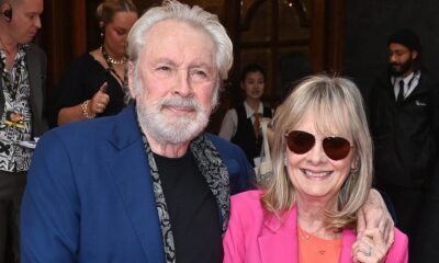 Twiggy, 74, looks sensational in a hot pink suit as she cosies up to her husband Leigh Lawson at Hello, Dolly! press night