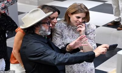 Princess Beatrice can't contain her laughter as eccentric artist Mr Brainwash enthusiastically shows her around exhibition - which features a painting of her uncle King Charles III behind the wheel of a silver Bentley